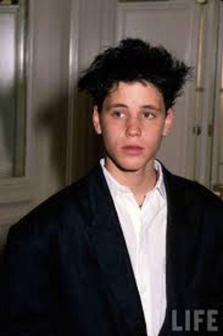 corey haim young, wearing a black jacket 